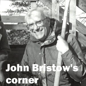 John Bristow's Corner: White words over a photograph of a smiling John Bristow, town historian