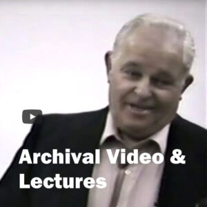 Words Archival video and Lecture- over a cor photo of man speaking